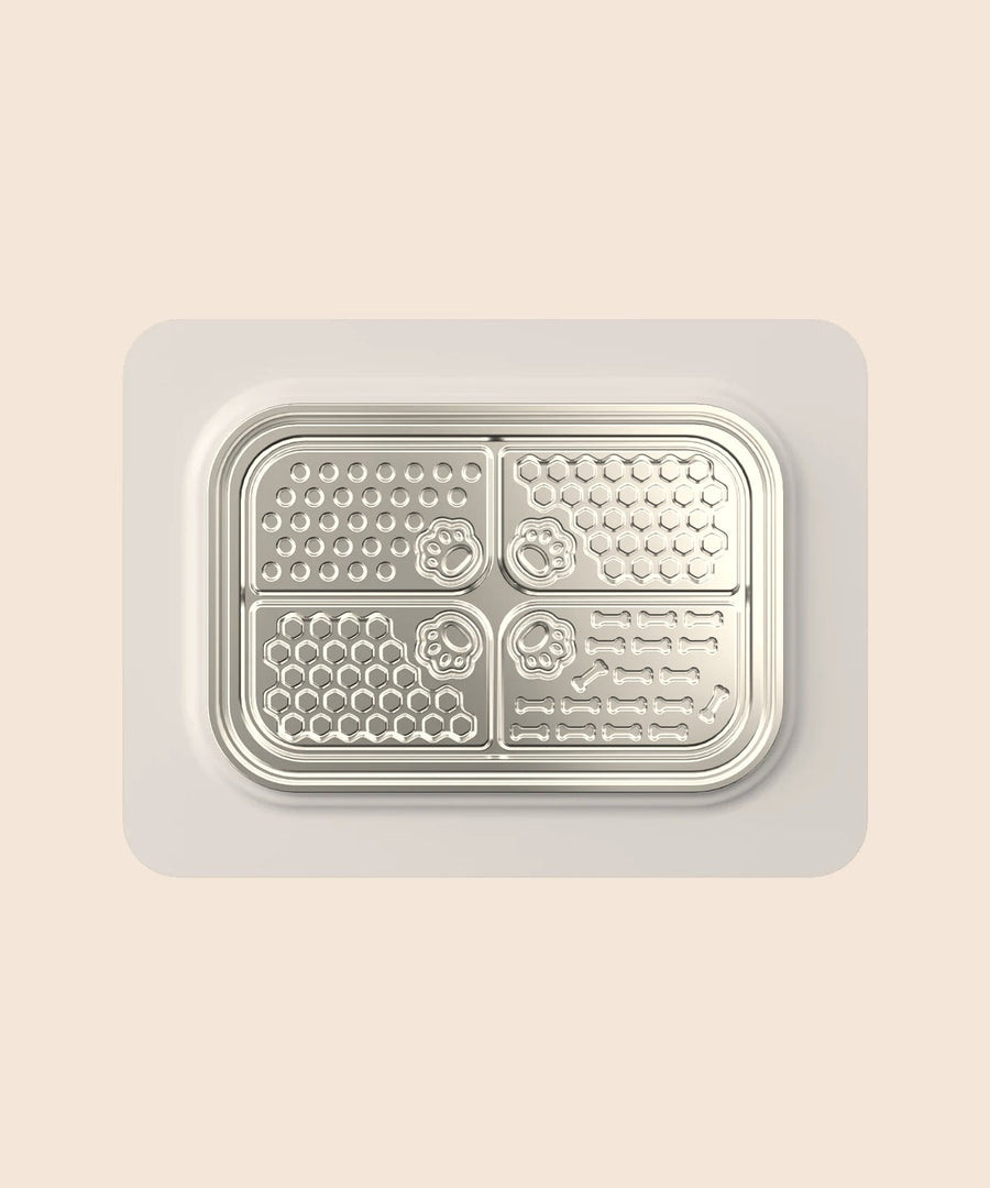 SteadyLick textured stainless steel lick plate on a grey silicone base