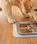 Golden retriever licking food from the SteadyLick steel lick plate