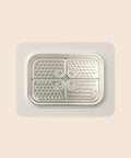 SteadyLick textured stainless steel lick plate on a grey silicone base